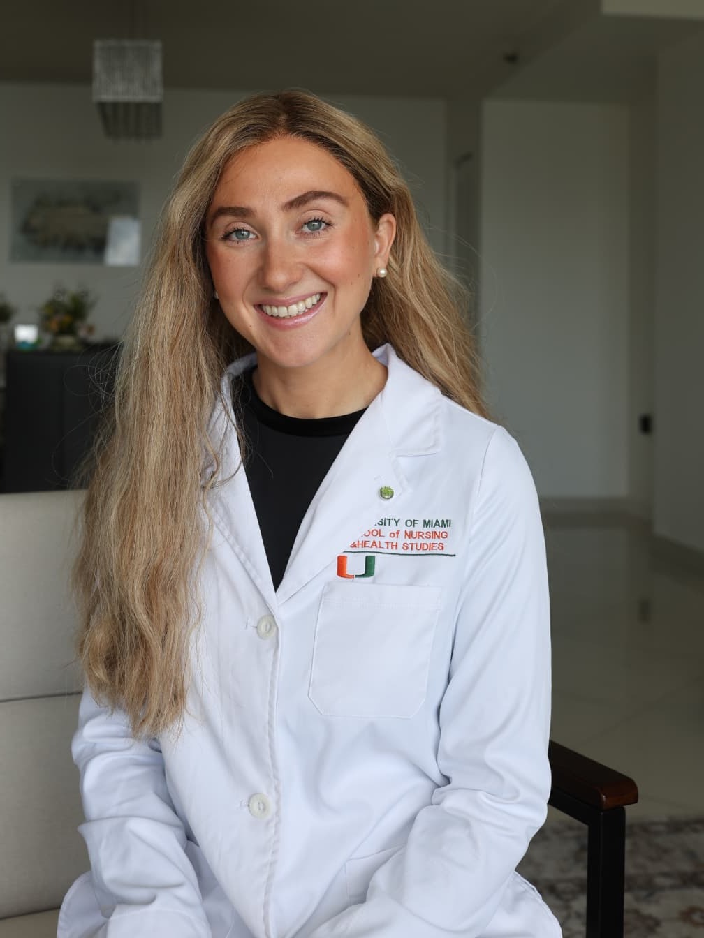 Sara in her nurse practitioner white coat
